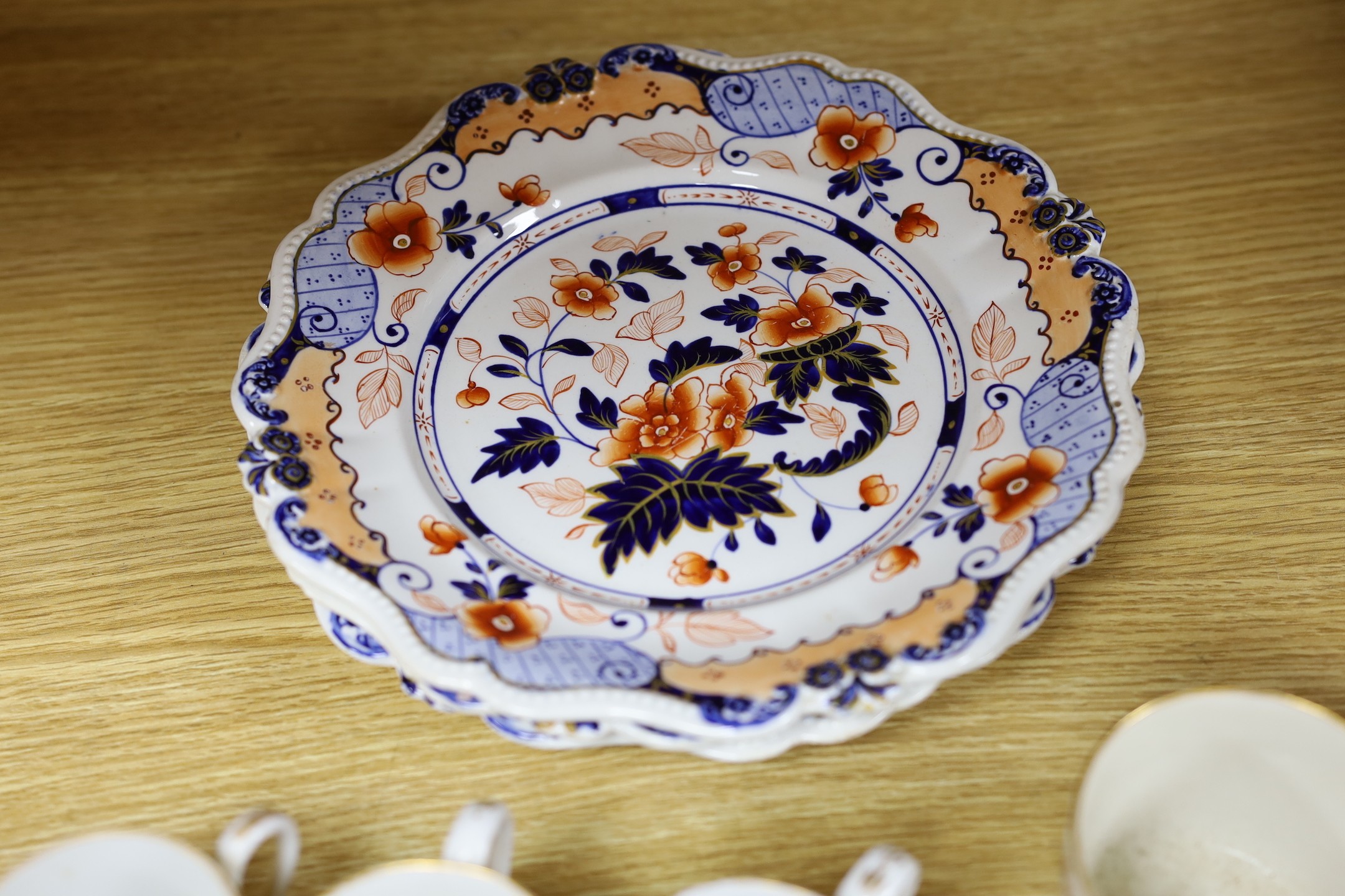 Seven early 19th century coffee cans and three Ridgway Imari style plates, plates 23 cms diameter